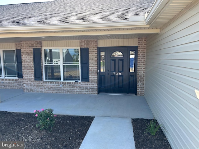 view of exterior entry with a porch