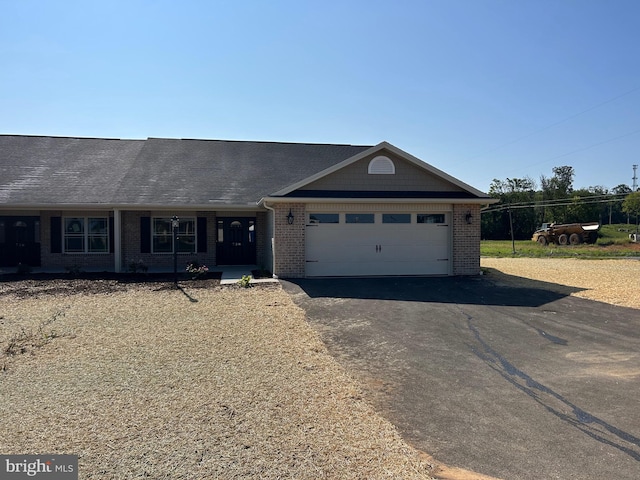 ranch-style home featuring a garage