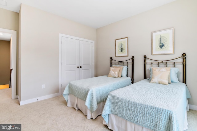 carpeted bedroom with a closet