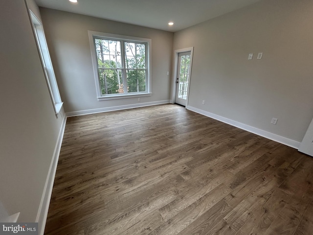 unfurnished room featuring dark hardwood / wood-style floors