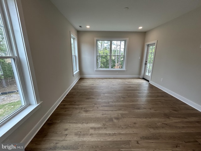 empty room with dark wood-type flooring