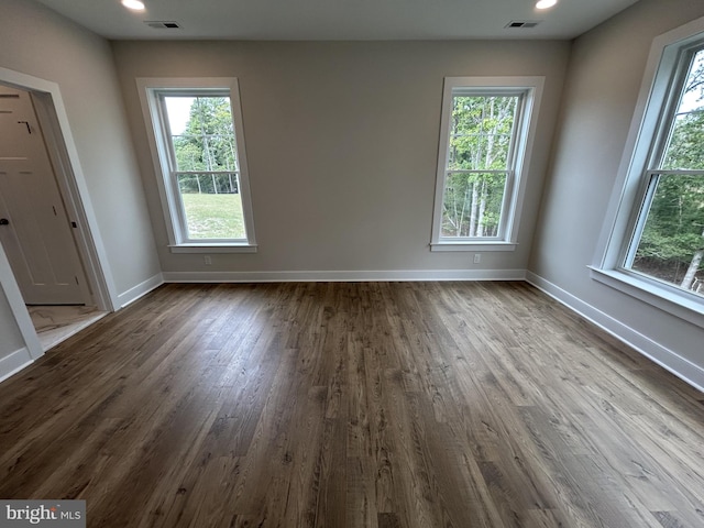 unfurnished room with hardwood / wood-style flooring