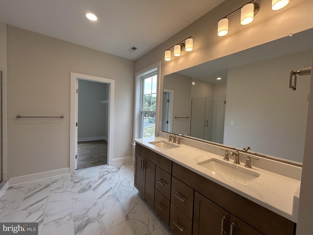 bathroom featuring walk in shower and vanity