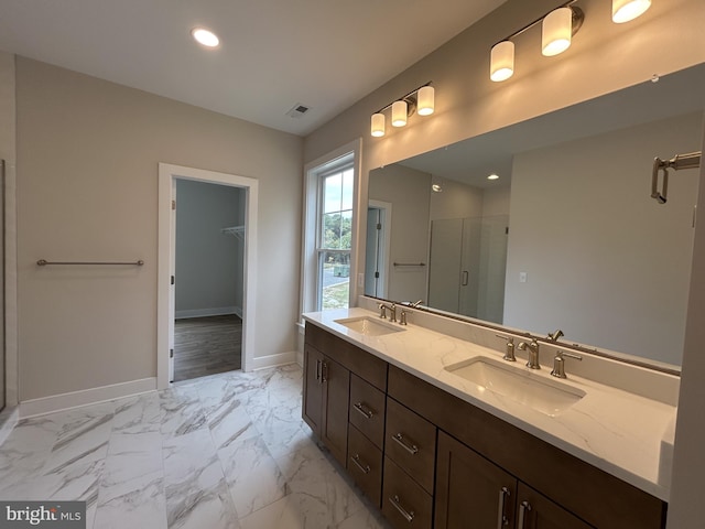 bathroom with vanity and a shower with shower door