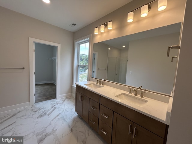 bathroom featuring vanity and a shower with shower door