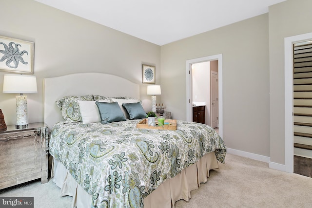 carpeted bedroom featuring connected bathroom