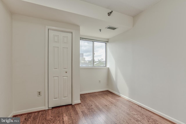 spare room featuring hardwood / wood-style floors