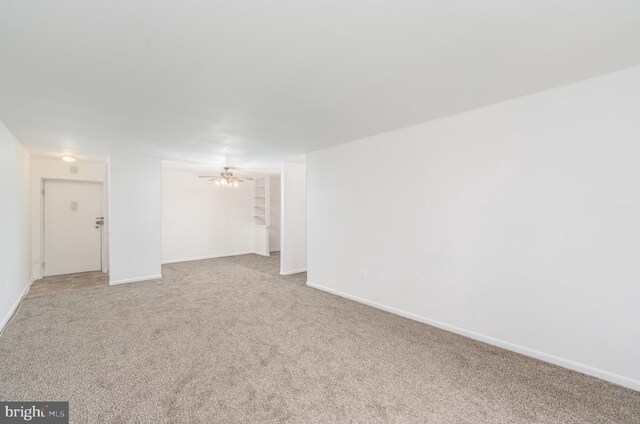 carpeted empty room featuring ceiling fan