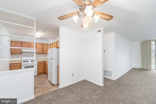 kitchen with white appliances, ceiling fan, and light colored carpet