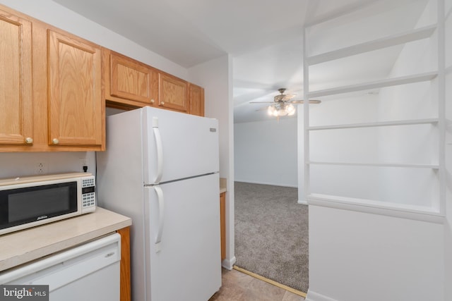 kitchen with light carpet, white appliances, ceiling fan, and light brown cabinetry