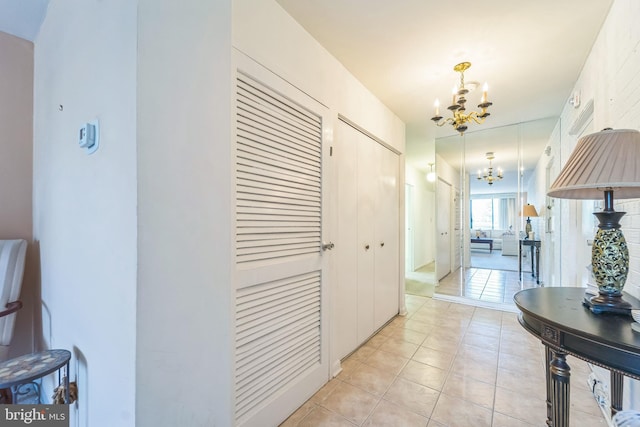 130 Slade Ave Unit 213, Pikesville, MD 21208 - hallway with an inviting chandelier and light tile patterned floors