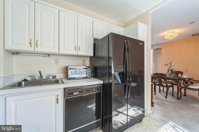 130 Slade Ave Unit 213, Pikesville, MD 21208 - kitchen featuring white cabinetry, black appliances, a toaster, and a sink