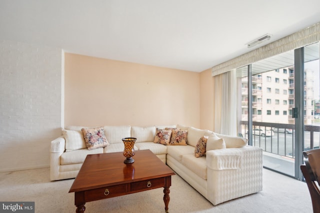 130 Slade Ave Unit 213, Pikesville, MD 21208 - carpeted living area featuring brick wall and visible vents