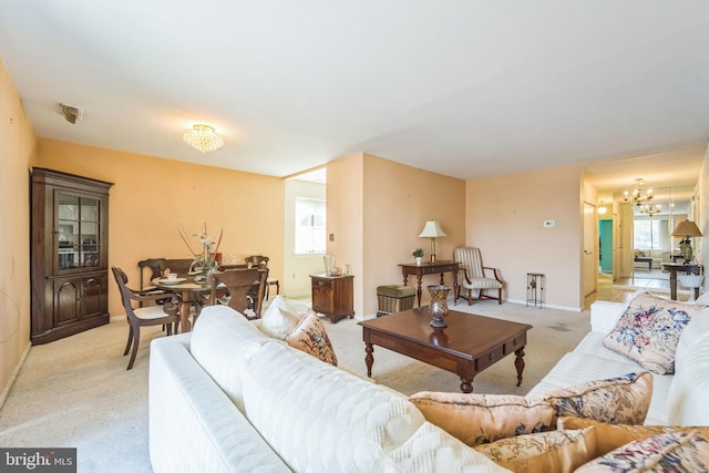 130 Slade Ave Unit 213, Pikesville, MD 21208 - living area featuring plenty of natural light, light carpet, baseboards, and a notable chandelier