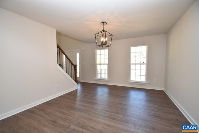 interior space with a chandelier, stairway, dark wood finished floors, and baseboards