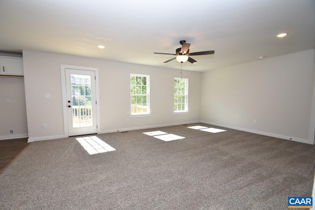 unfurnished living room with ceiling fan, dark carpet, recessed lighting, and baseboards