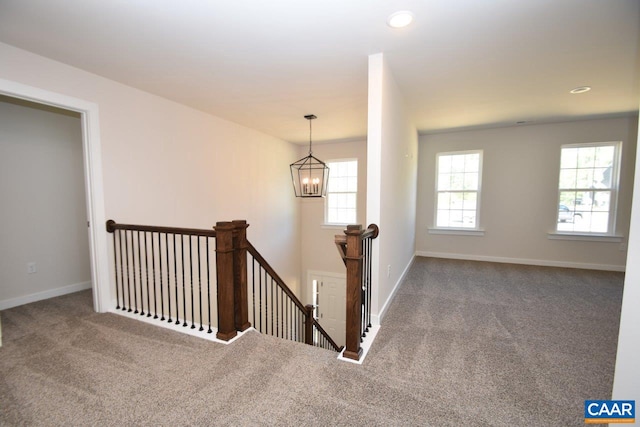 stairway with baseboards, carpet floors, recessed lighting, and a notable chandelier