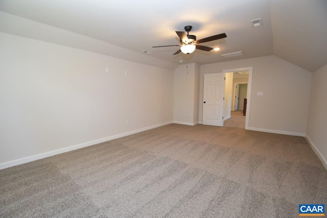 interior space with carpet floors, lofted ceiling, ceiling fan, and baseboards