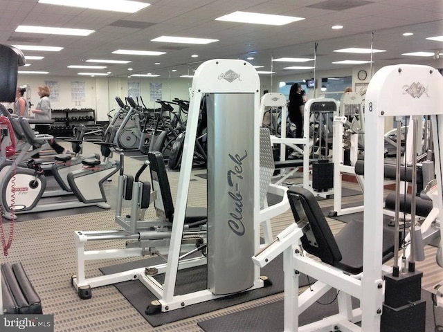 exercise room with a paneled ceiling