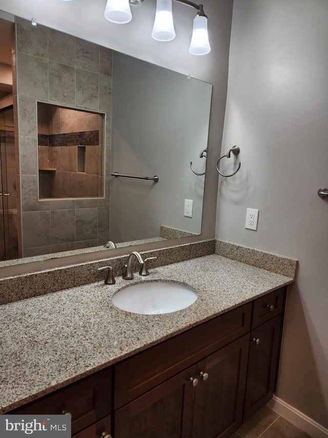 bathroom with tile patterned floors and vanity