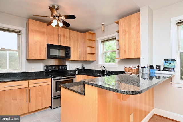 kitchen with ceiling fan, dark stone countertops, kitchen peninsula, and electric range