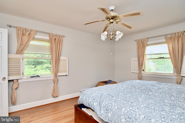 bedroom with ceiling fan and light hardwood / wood-style flooring