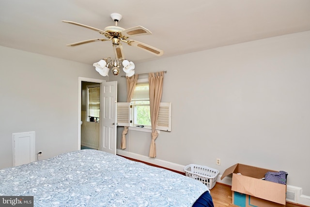 bedroom with ceiling fan and hardwood / wood-style flooring