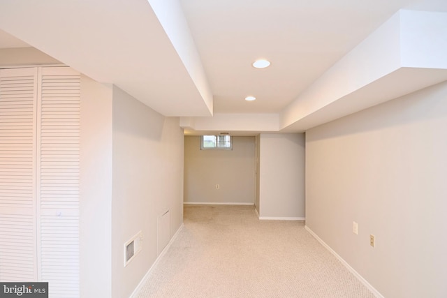 basement with light colored carpet