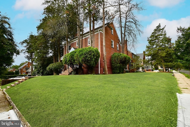 view of side of home with a lawn