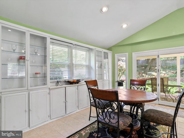 dining room featuring lofted ceiling, light tile patterned flooring, and recessed lighting