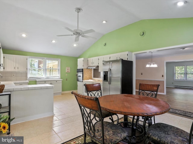 dining area with light tile patterned flooring, recessed lighting, ceiling fan with notable chandelier, baseboards, and vaulted ceiling