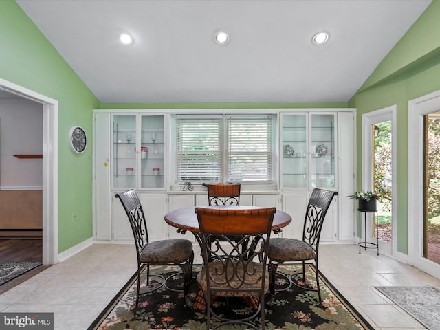 dining area with recessed lighting, baseboard heating, light tile patterned flooring, vaulted ceiling, and baseboards