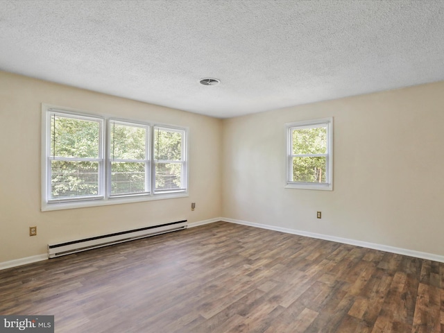 unfurnished room with baseboards, visible vents, a baseboard radiator, wood finished floors, and a textured ceiling