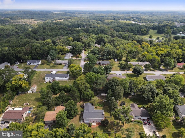 drone / aerial view with a wooded view