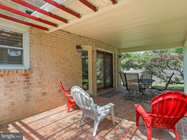 exterior space with outdoor dining space and fence