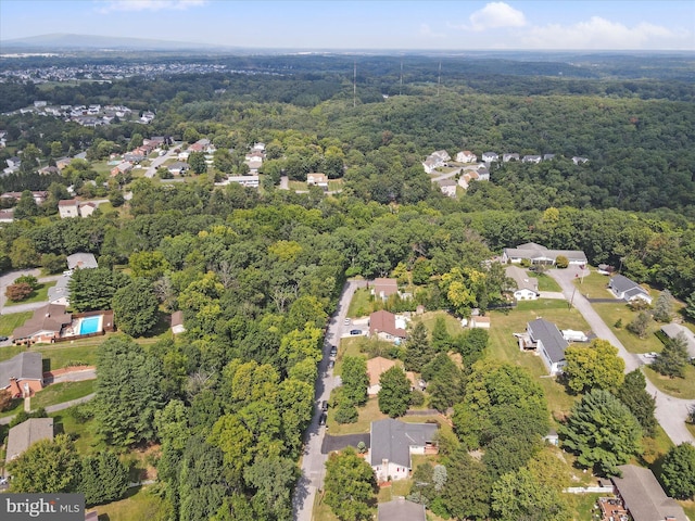 birds eye view of property with a wooded view