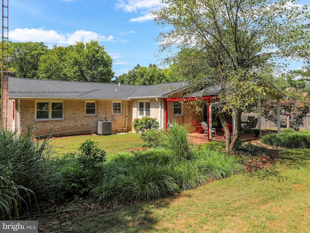 ranch-style house featuring brick siding, a patio area, central AC unit, and a front yard