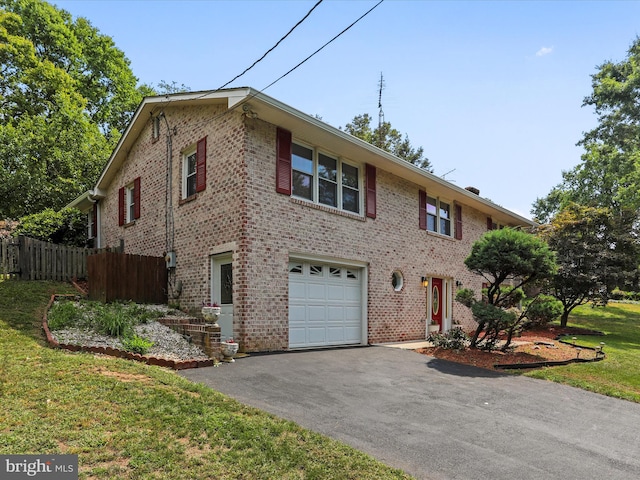 view of front facade with a garage, aphalt driveway, fence, a front lawn, and brick siding