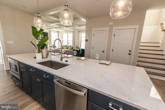 kitchen featuring light hardwood / wood-style floors, appliances with stainless steel finishes, sink, and coffered ceiling