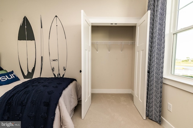 carpeted bedroom featuring a closet