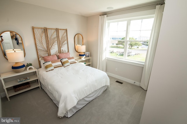 bedroom with carpet flooring, visible vents, and baseboards