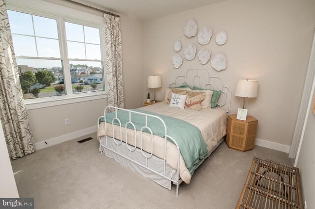 bedroom featuring light colored carpet