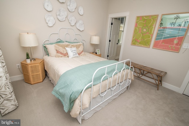 bedroom with light carpet and baseboards