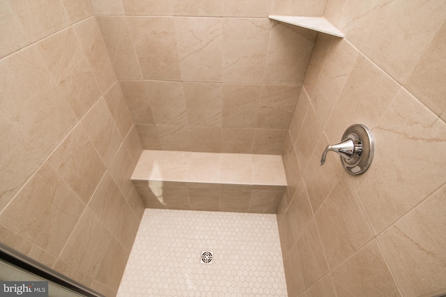 bathroom with a tile shower