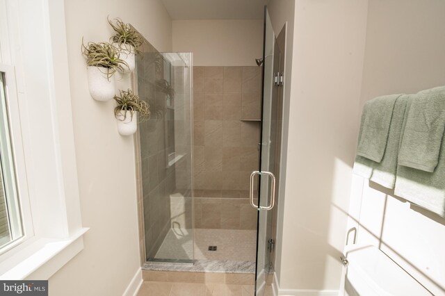 bathroom with a shower with shower door