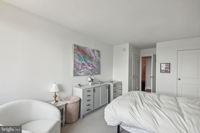 bedroom featuring light carpet