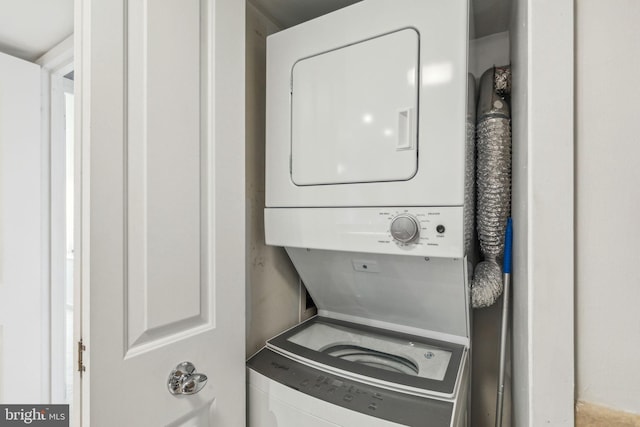 clothes washing area featuring laundry area and stacked washer / dryer