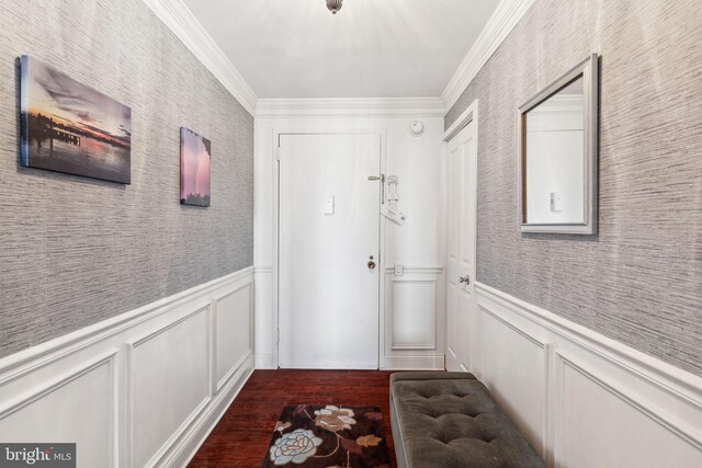 doorway with wood-type flooring and crown molding