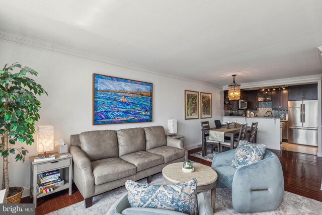 living room with dark hardwood / wood-style floors and ornamental molding