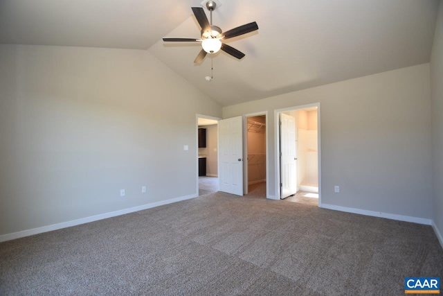 unfurnished bedroom featuring a walk in closet, light colored carpet, ceiling fan, and a closet